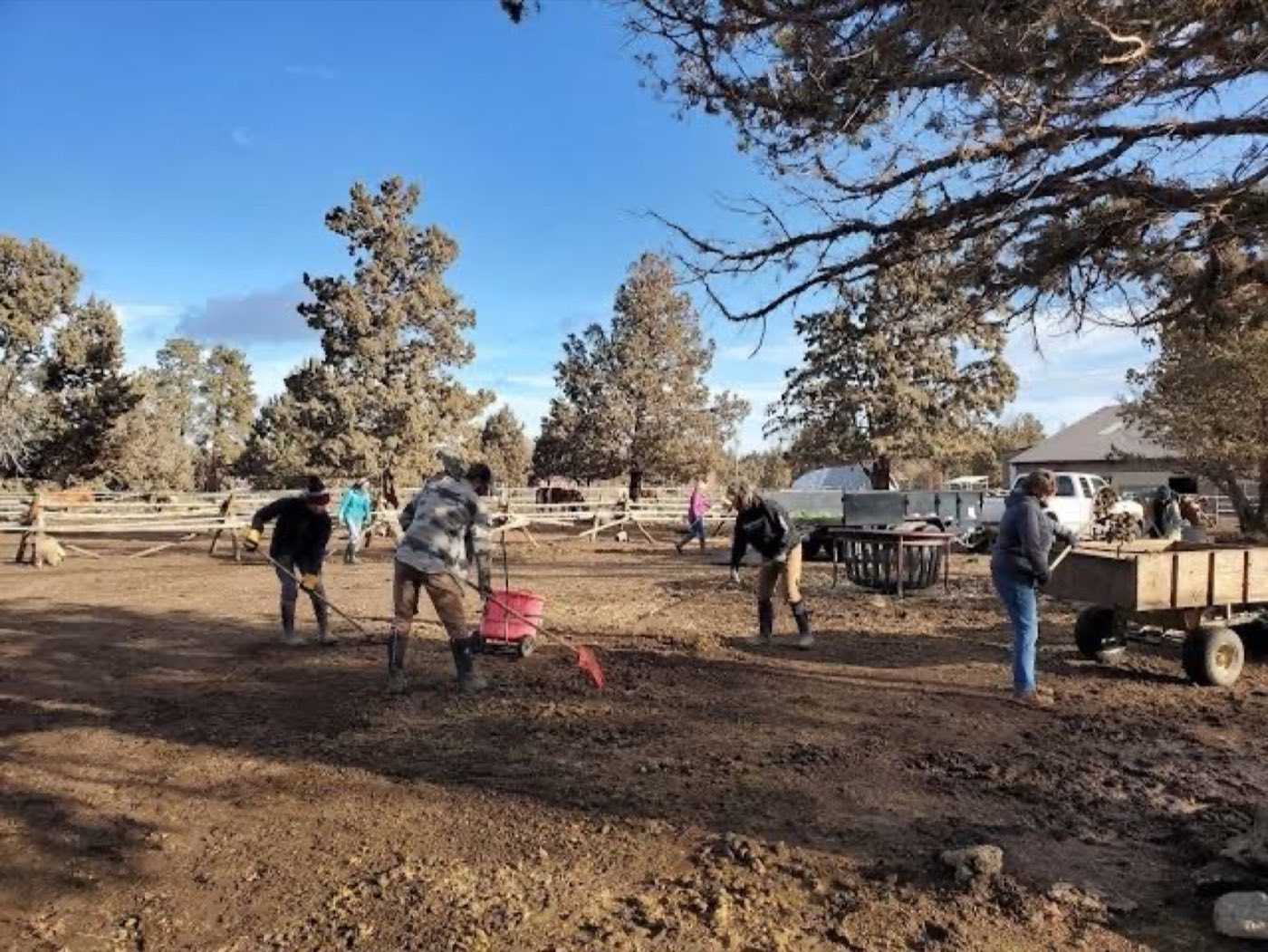 Volunteers raking and hauling at an outdoor work day